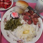 Easter dinner of baked ham, mashed potatoes, roasted asparagus, a Jello egg with whippe topping, homemade roll, and strawberries