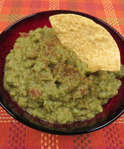A bowl of Pantry Guacamole with a tortilla chip in it