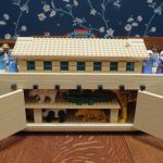 Open "Lego" ark with animals inside and people on deck.