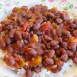 A bowl of black beans and salsa over rice