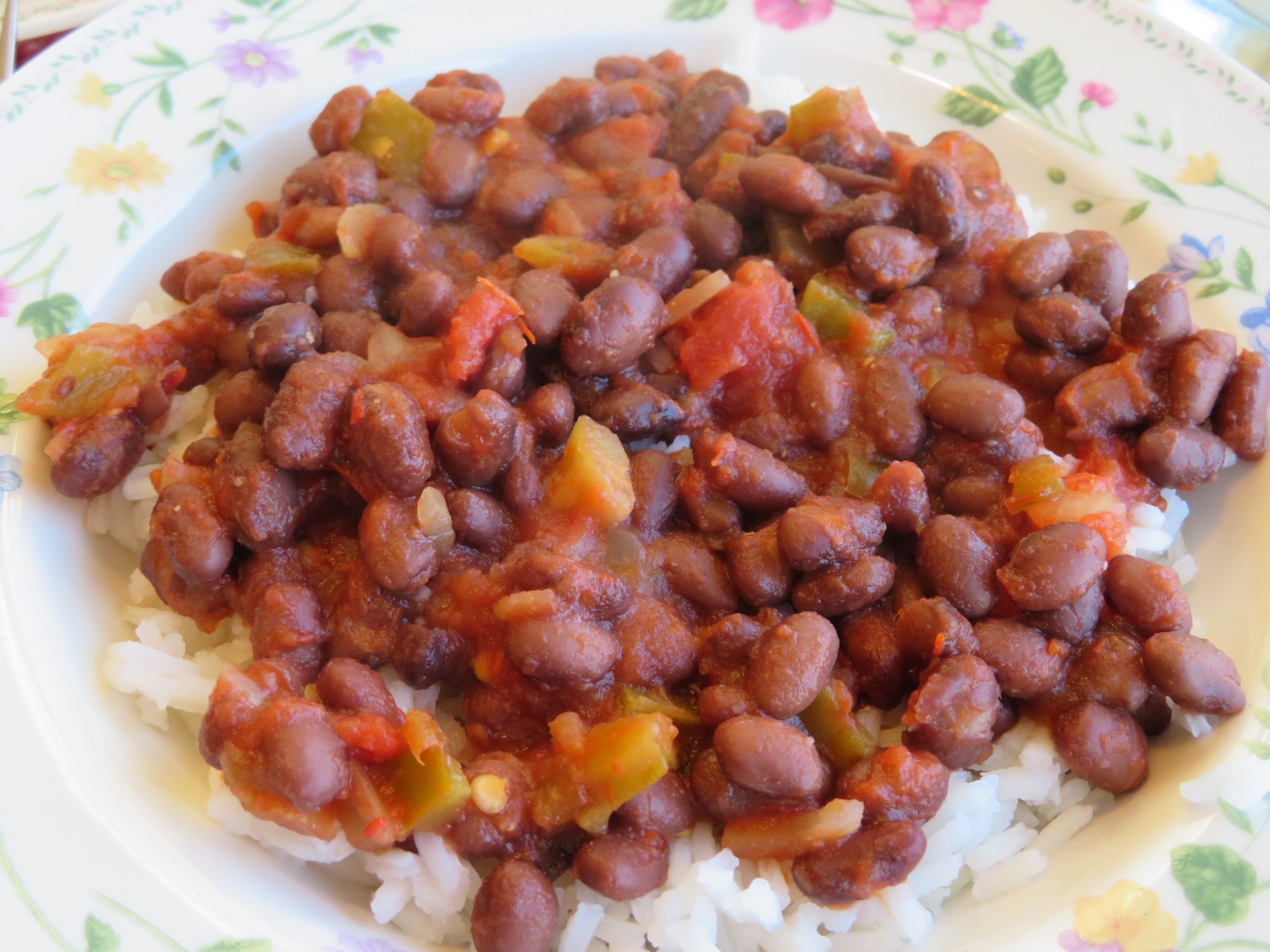 A bowl of black beans and salsa over rice