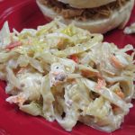 Pickled Cabbage Slaw on a red plate with a BBQ sandwich
