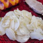 Warm Vinegar and Dill Potato Salad on a red plate