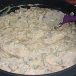 A skillet of chicken in mushroom cheese sauce