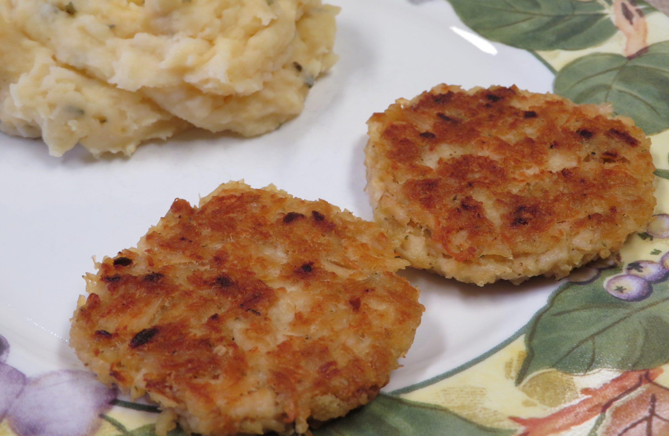 Two Chicken Patties on a plate with Mashed Potato Salad