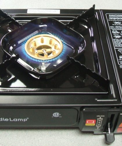 A lit tabletop butane stove