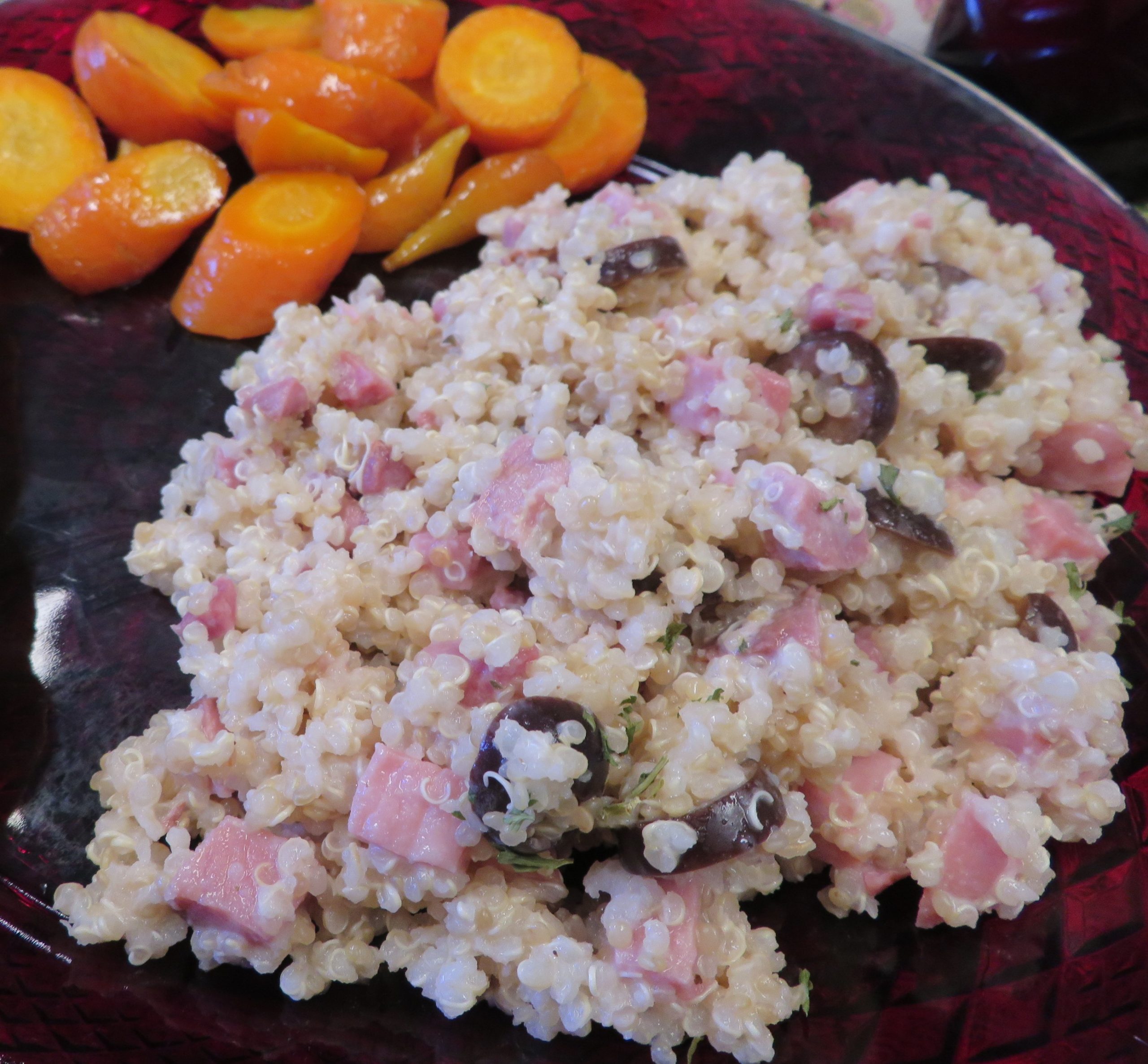 Quinoa and Ham Salad with Ranch dressing and olives on a plate